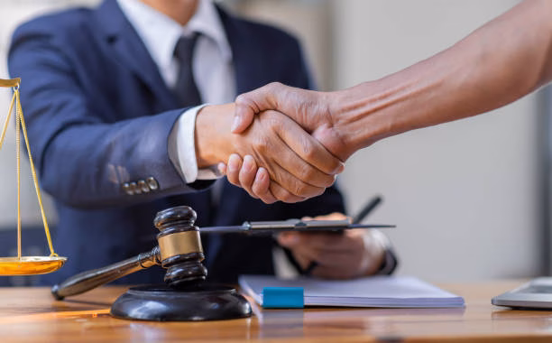 Lawyer who provides legal advice in the office. Businessman and lawyer shaking hands.